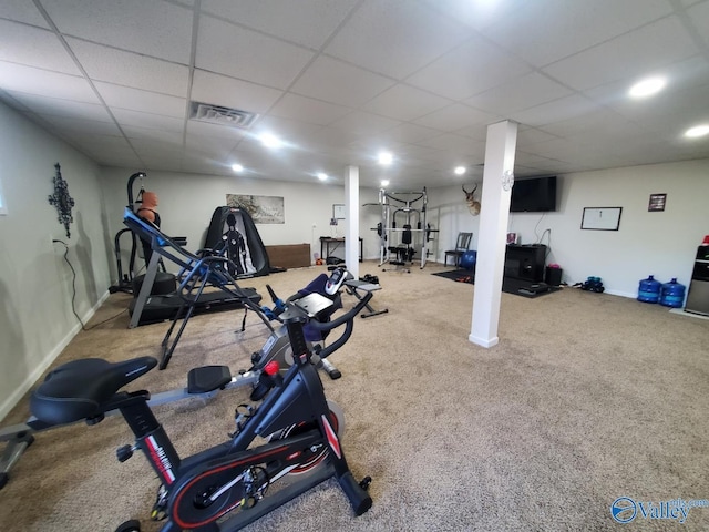 workout room featuring a drop ceiling and carpet flooring