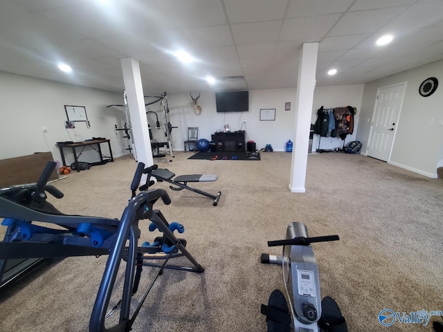 exercise area with a paneled ceiling and carpet floors