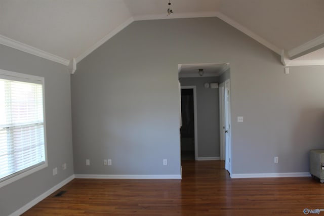 unfurnished room with baseboards, vaulted ceiling, crown molding, and wood finished floors