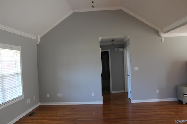 spare room with ornamental molding, vaulted ceiling, and wood finished floors