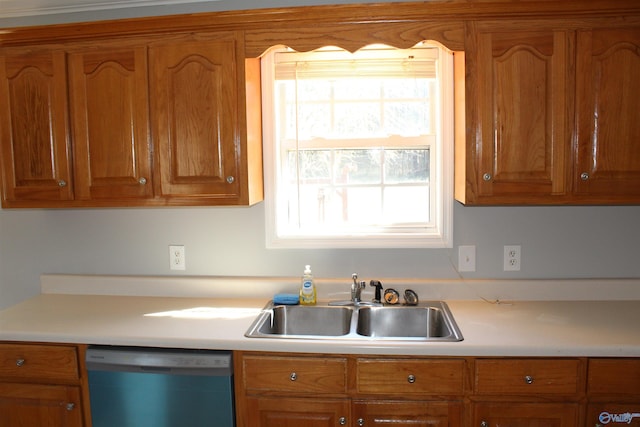 kitchen with dishwashing machine, light countertops, a sink, and brown cabinetry