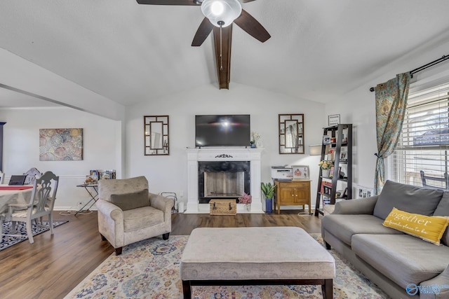 living room with wood-type flooring, lofted ceiling with beams, and ceiling fan