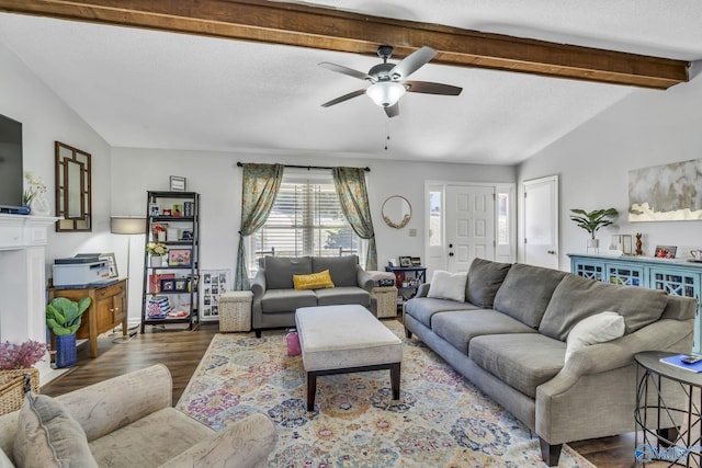 living room with ceiling fan, vaulted ceiling with beams, a textured ceiling, and dark hardwood / wood-style floors