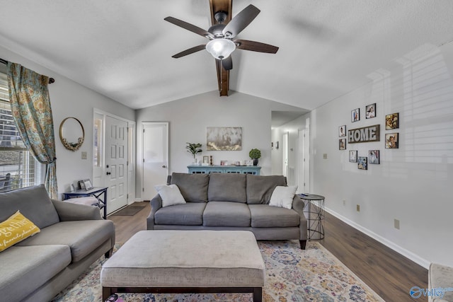 living room featuring vaulted ceiling with beams, a textured ceiling, dark hardwood / wood-style floors, and ceiling fan