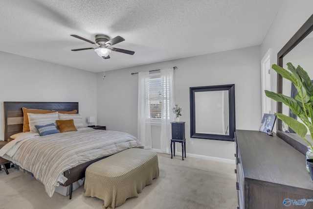 bedroom with light carpet, a textured ceiling, and ceiling fan