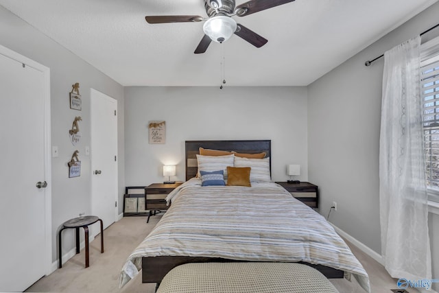 carpeted bedroom with a textured ceiling and ceiling fan