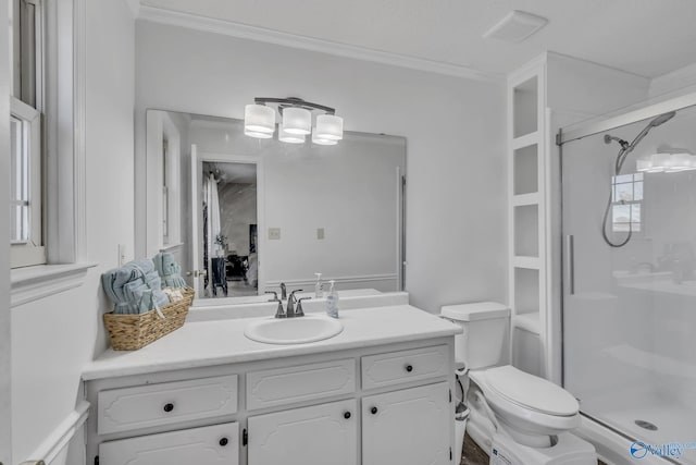 bathroom featuring crown molding, vanity, toilet, and a shower with shower door