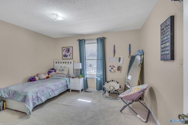 bedroom featuring carpet floors and a textured ceiling