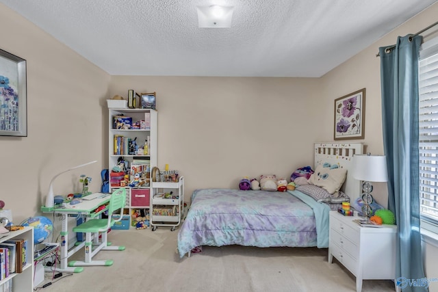 carpeted bedroom featuring a textured ceiling