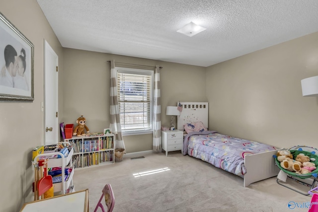 carpeted bedroom with a textured ceiling