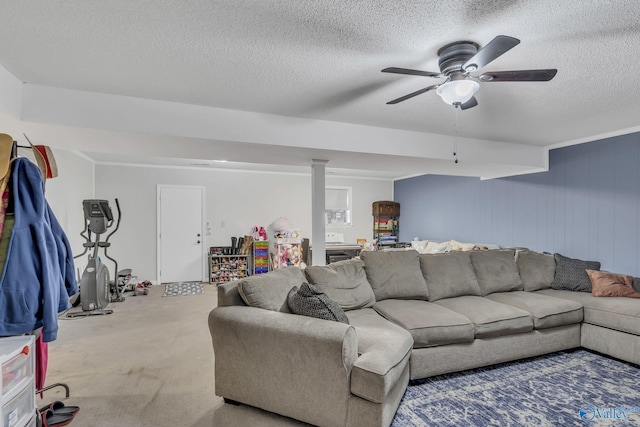 living room featuring ceiling fan and a textured ceiling