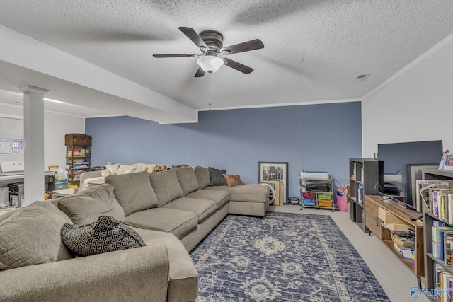 living room with ceiling fan, carpet floors, ornamental molding, and a textured ceiling