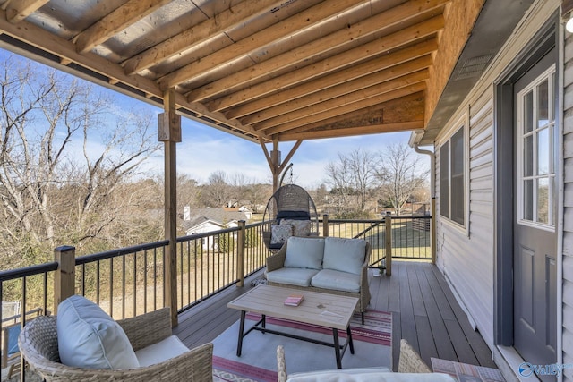 wooden terrace with an outdoor living space