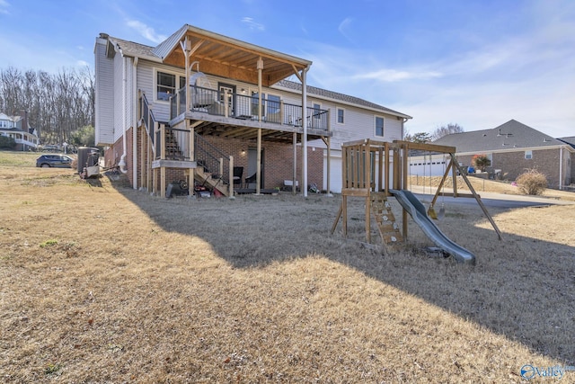 rear view of house with a yard, a playground, and a deck