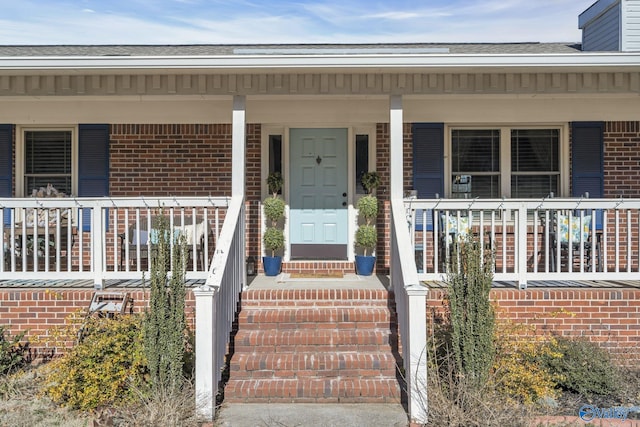 doorway to property featuring covered porch