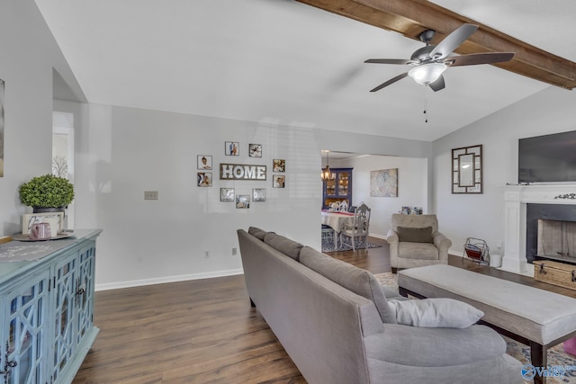 living room with ceiling fan, dark hardwood / wood-style floors, and vaulted ceiling with beams