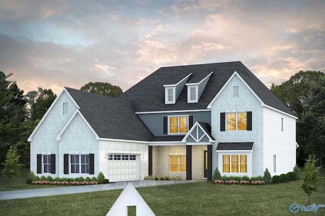 view of front of property with a yard and a garage