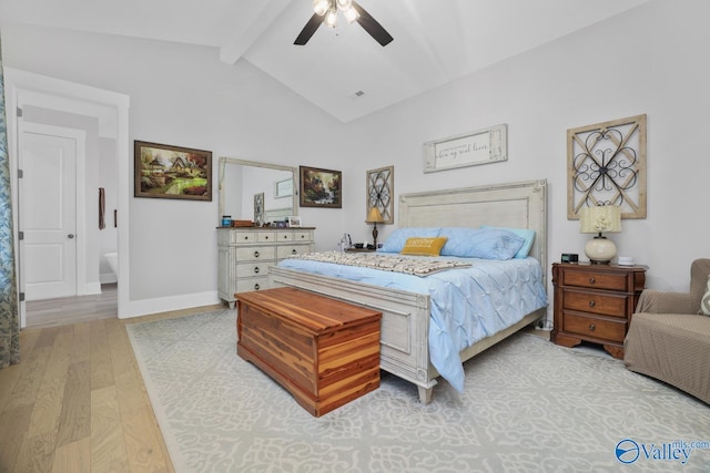 bedroom with ceiling fan, light hardwood / wood-style flooring, and vaulted ceiling with beams