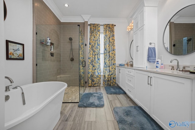 bathroom with separate shower and tub, vanity, hardwood / wood-style flooring, and crown molding