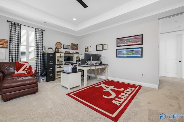 office area with ceiling fan, ornamental molding, a raised ceiling, and carpet