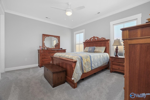 carpeted bedroom with ceiling fan and crown molding