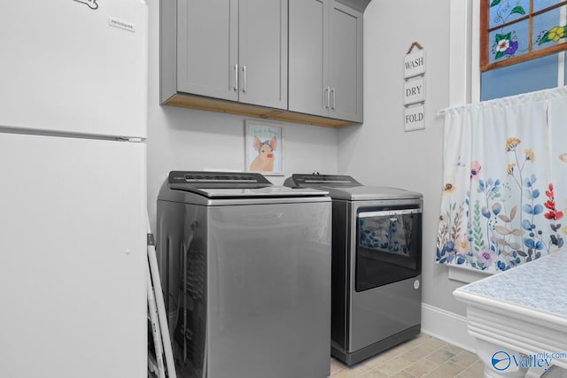 laundry area with cabinets and washer and dryer