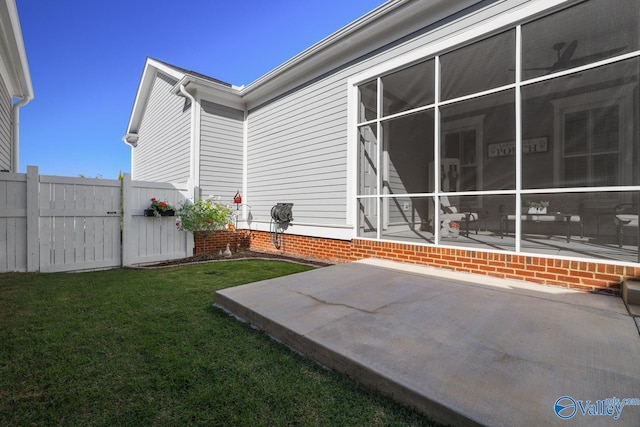 view of yard with a sunroom and a patio