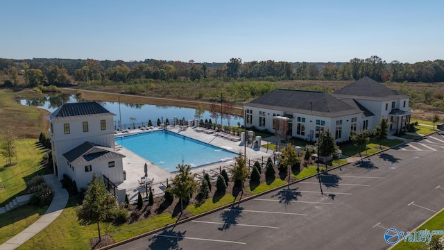 view of pool featuring a patio and a water view