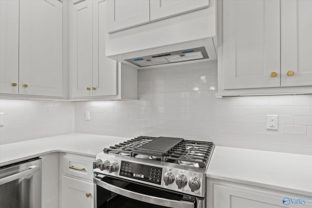 kitchen with white cabinets, backsplash, and appliances with stainless steel finishes