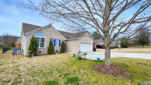 view of front of property with a front yard, an attached garage, concrete driveway, crawl space, and brick siding