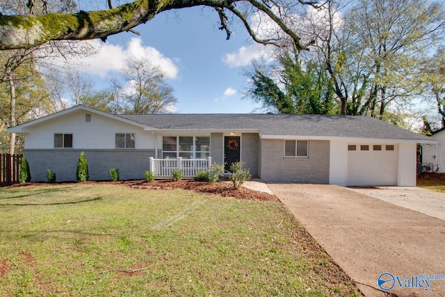 ranch-style house with covered porch, a garage, and a front lawn