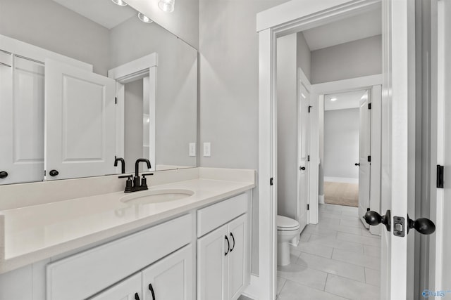 bathroom featuring toilet, tile patterned floors, and vanity