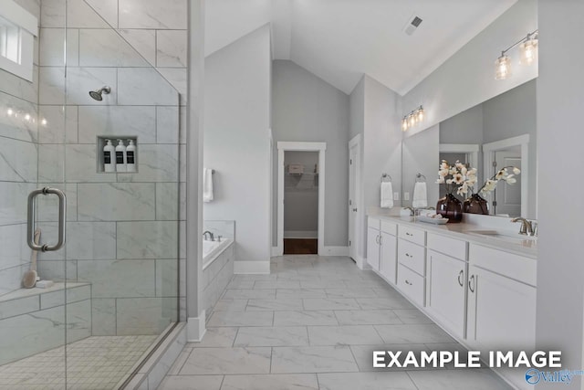 full bath featuring marble finish floor, a stall shower, and a sink