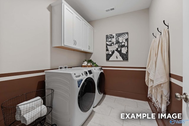 laundry room with cabinet space, washing machine and dryer, visible vents, and baseboards