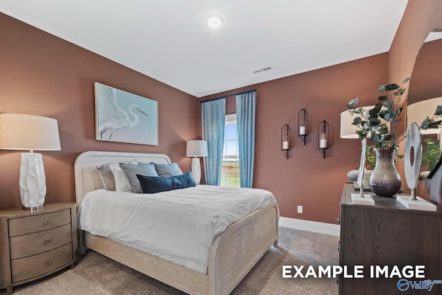 bedroom featuring light carpet, visible vents, and baseboards