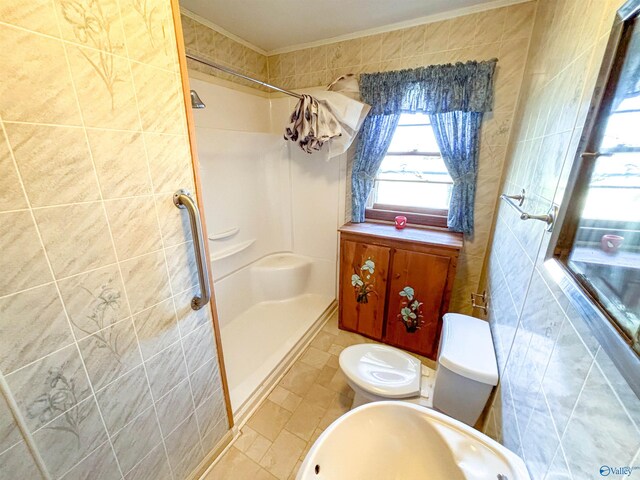 bathroom featuring toilet, tile patterned flooring, tile walls, and crown molding