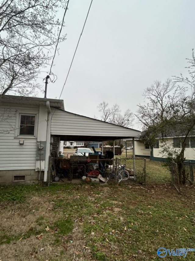 exterior space featuring a carport and a yard