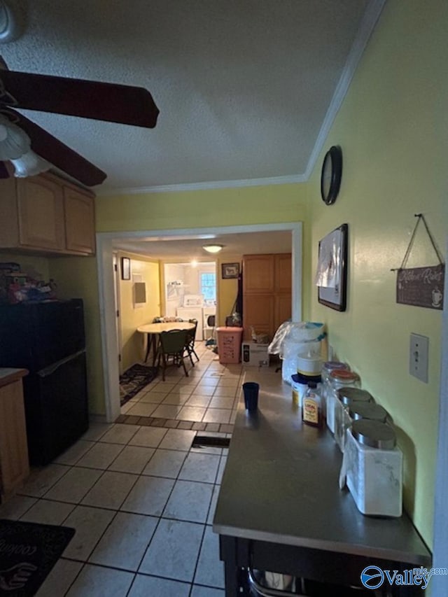 tiled dining area with crown molding and ceiling fan