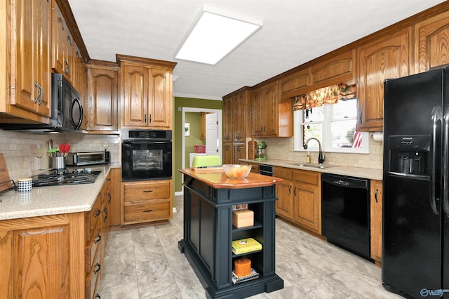 kitchen featuring black appliances, decorative backsplash, crown molding, and sink