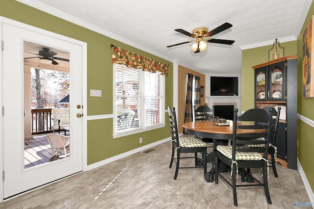 dining area featuring ceiling fan and crown molding