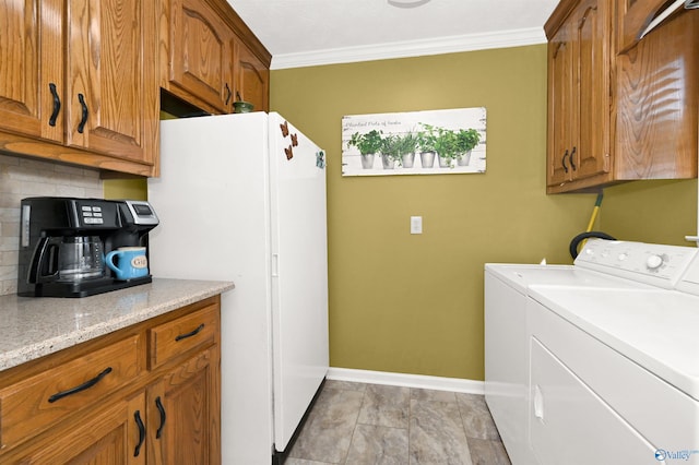 washroom with separate washer and dryer and crown molding