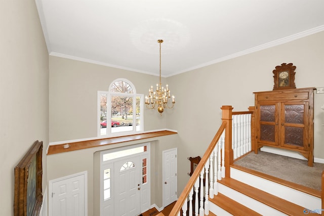 foyer with a chandelier, wood-type flooring, and ornamental molding