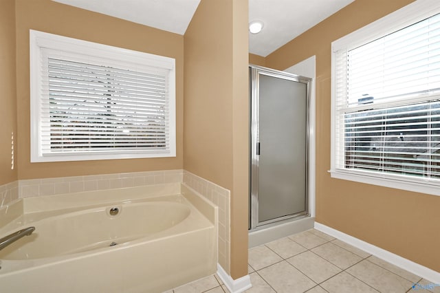 bathroom featuring tile patterned flooring and shower with separate bathtub