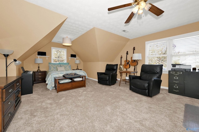 carpeted bedroom featuring multiple windows, ceiling fan, and vaulted ceiling