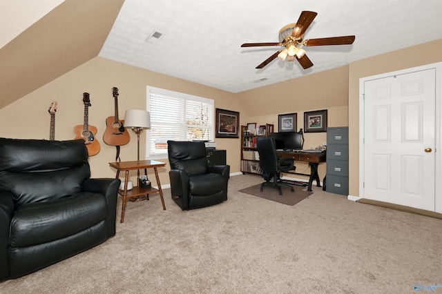 office space featuring carpet, a textured ceiling, vaulted ceiling, and ceiling fan