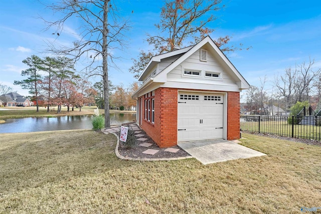 garage with a yard and a water view