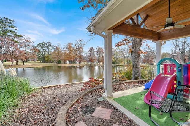 view of jungle gym with a water view and ceiling fan