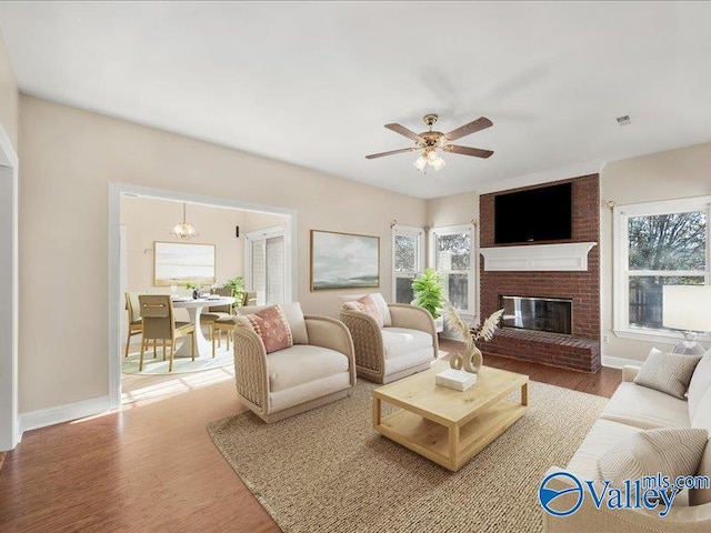 living room featuring a fireplace, ceiling fan, and hardwood / wood-style floors