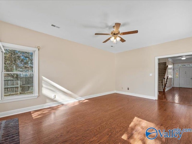 spare room featuring ceiling fan and dark hardwood / wood-style flooring