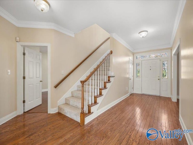 foyer with hardwood / wood-style flooring and ornamental molding